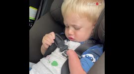 Brave boy with one hand is determined to buckle himself up *INSPIRING*