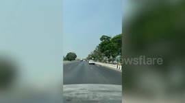 Styrofoam lid amusingly flies above moving car on highway