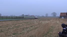 Rally car out of control, car ends up in the field. Supporters push the car back onto the track.