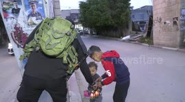 Palestinian soldiers out lanterns to children at Jenin refugee camp during Ramadan celebrations