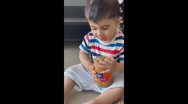 Cute baby loves to eat Peanut Butter.