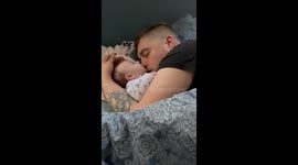Adorable sleeping baby girl in Belgium 'eats' dad's nose as they snooze together