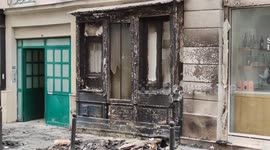 Debris and ashes line Parisian street after pension reform protesters wreak havoc