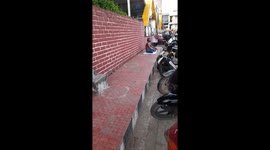Senior Man Smoking While Sitting On roadside  Footpath in India