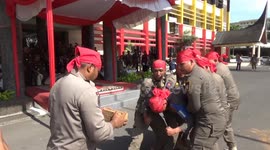 Headbangers! Indonesian police break layers of bricks with their skulls to show they're capable of fending attacks