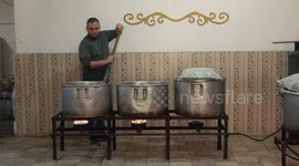 Palestinian chefs cook chickens and rice on firewood by burying them inside a barrel underground, to sell it to customers during the holy month of Ramadan in Gaza city