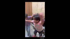 Two boy cousins having fun in first rainfall of summer monsoon