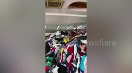 Huge mounds of seconhand clothes clutter warehouse in Thailand