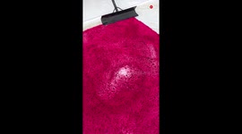 Footage of water getting wiped off a red rug is BEYOND SATISFYING & LOVELY