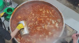 Palestinians prepare a dish for free fast-breaking Iftar rations to families in need, at the Ibrahimi Takiya during the Muslim holy month of Ramadan in the West Bank city of Hebron