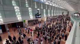 Tokyo's Haneda Airport crowded with stranded passengers as system failure hits All Nippon Airways