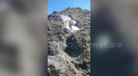 Scary moment large stones tumble down from mountain onto Indian highway