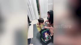 Toddler's head stuck inside suitcase handle before father easily lifts it off