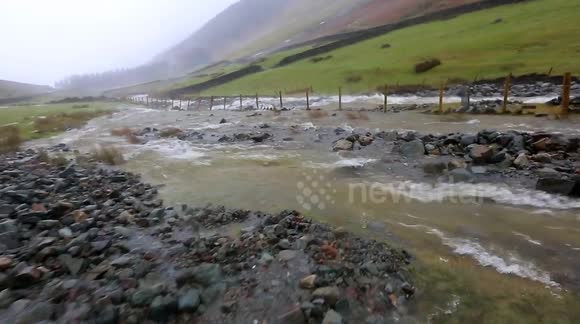 River crashes down Cumbrian fellside spewing rubble as it goes