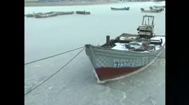 Fishing boats completely stuck in frozen sea