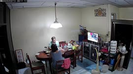 Electric fan bursts open next to eating couple