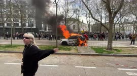 Protesters set car on fire in Paris