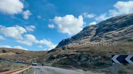 Timelapse of busy tourist filled A82 Glencoe road on a beautiful sunny Easter Saturday