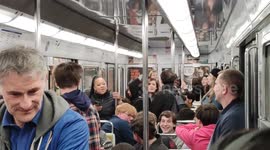 Paris: A tourist sings and suddenly all passengers sing with her.  The subway metro was locked at station Kleber near the Arc-de-Triomphe and the Champs-Elysées since a few minutes without explanation, then passengers started to sing to spend time.  8 apr