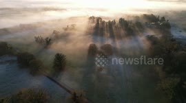 Drone flight at sunset with beautiful fog and long shadows created by the setting sun