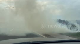 the driver pulls through the fire, thick smoke on the road