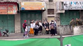 Israeli security forces stand guard during a visit by Jewish settlers in Hebron city