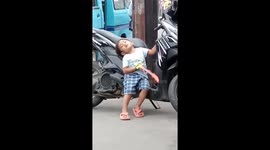 Sleepy little biker boy: a funny moment in Bandung, West Java