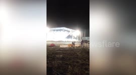 Stage banner billows as storm gusts batter theatre venue in Thailand