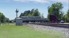 WTF Moment: Truck Knocks Off Railroad Crossing Arm Which Also Collides With a Train