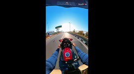 'CLOSE CALL!' - Risk-taking biker speeds through extremely narrow gap between 2 trucks