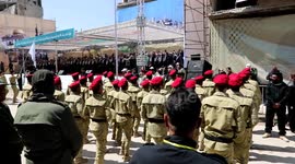 Palestinian youth from different factions take part in a military parade at the heavily damaged Yarmuk refugee camp in southern Damascus to mark Al-Quds (Jerusalem) Day