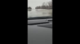 Minnesota woman driving home from work gets caught in the middle of flooding roads. Just trying to get home.