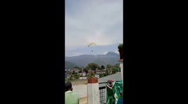 Paraglider crashes on pavement at high speed, miraculously survives