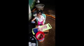 Baby's on the go to help, she is willing to help her mom to do laundry.