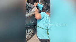 Passing office workers help save kitten trapped under car
