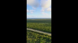 Flying down to Punta Cana Dominican Republic filmed from airplane cabin