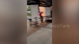 Powerful winds push tables and chairs into pool at condominium in Thailand