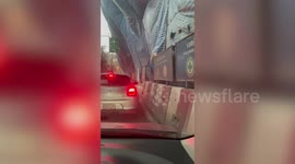 Canvas covering road construction crashes down on cars as powerful winds blow