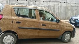 Indian homeopath coats his car in cow dung to beat heatwave - and claims it works wonders!