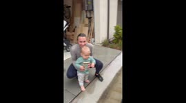 Mom helping baby boy unlock his ability to jump in the rain