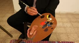 Palestinian artist Jihad Al-Sharafi, 48 years old, paints a painting in his private studio in Gaza city.