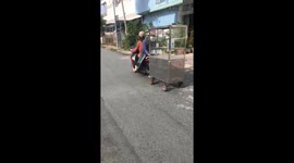 Two women pulling a glass cabinet selling goods on motorbikes moving on the street