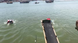 Contestants bob up and down during basket boat race in Vietnam