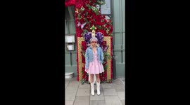 Influencer Megan Bacon-Evans poses in front of elaborate floral Coronation display at The Ivy in Windsor, located by Windsor Castle