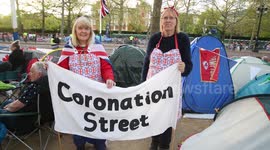 Interview with various members of the public waiting for the Royal Coronation. Includes 2 women who have a fun sign