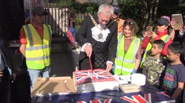 Lord Mayor of London cuts coronation cake at street party in City of London