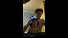 Father's gaming session lulls daughter to sleep with headphones on
