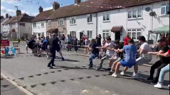 Hilarious moment rope snaps during game of tug of war in celebration of ...
