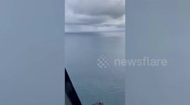 Double waterspout tornado forms at sea during off-shore tropical rain shower in Thailand