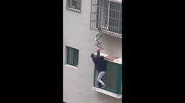 Heroic Chinese men hold up toddler hanging from window until help arrives